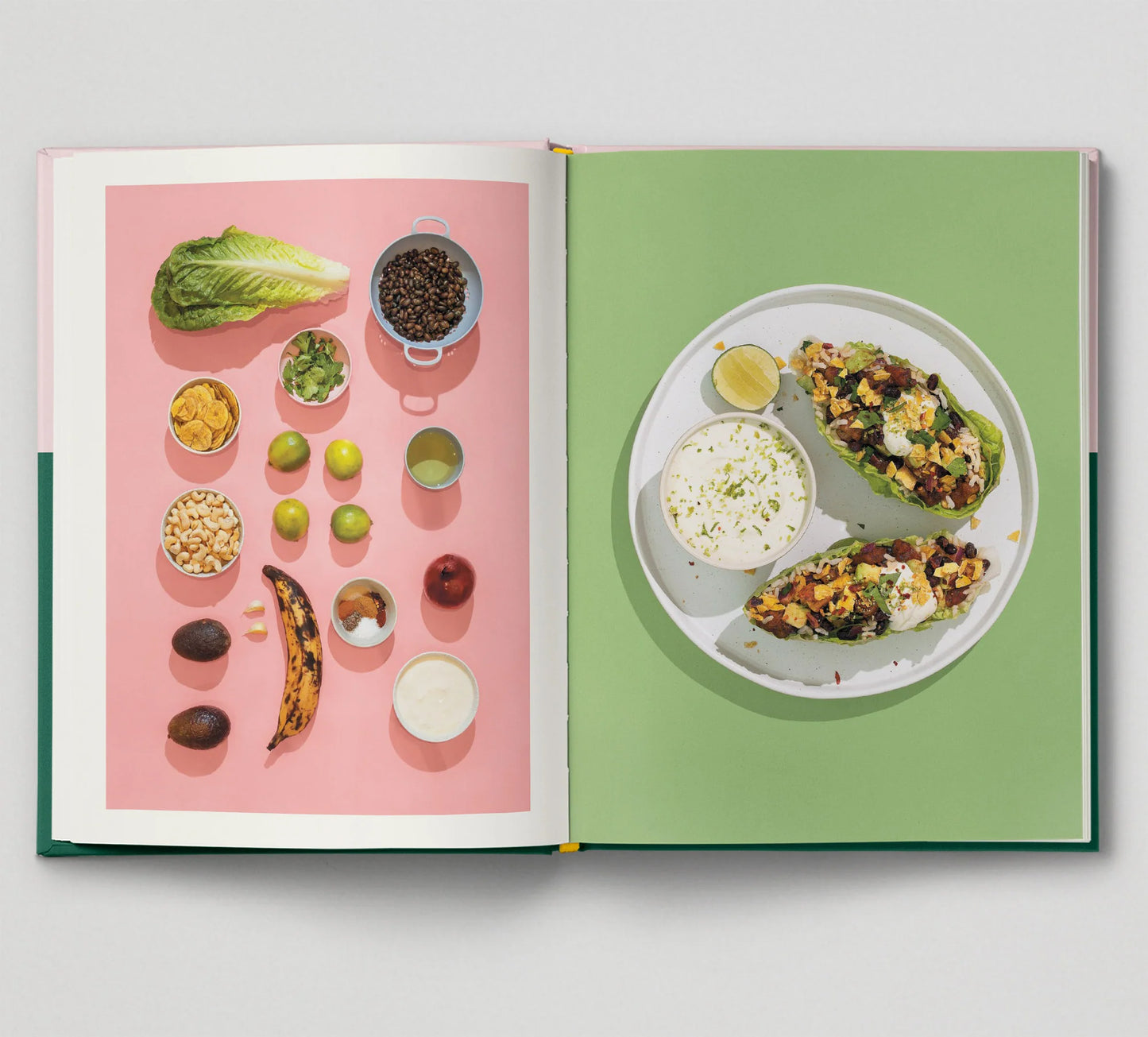 The left page presents colorful ingredients such as lettuce, beans, nuts, limes, plantain, and avocado. The right page displays stuffed avocados on a white plate with Barbados hot pepper sauce and lime—ideal for aficionados of the Afro-Vegan cookbook! From Sonia's Vokalized Kreations: Seasoned.