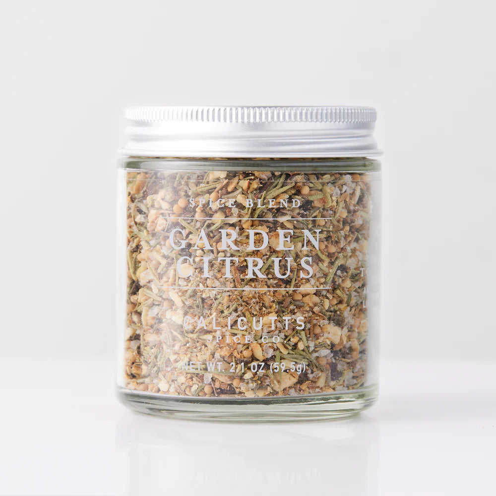 A jar of "Seasoned" from Sonia's Vokalized Kreations features a blend of herbs and spices, ideal for seafood. It's in a clear jar with a silver lid and weighs 2.1 oz (59.5 g).