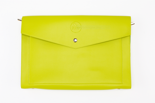 The Pompei Clutch from Sonia's Vokalized Kreations is a bright green leather piece with a bold envelope design, featuring a central silver button and embossed logo.