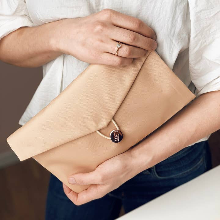 Beige small diaper bag in clutch form