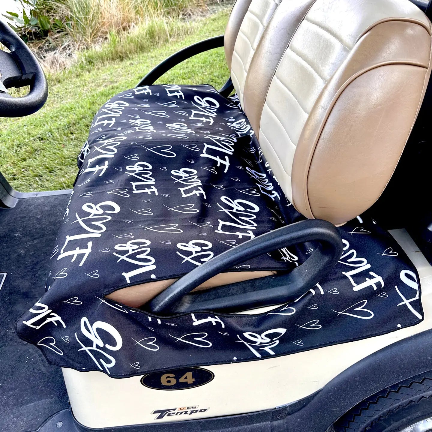 Golf cart seat with a blue cover featuring white text and designs.