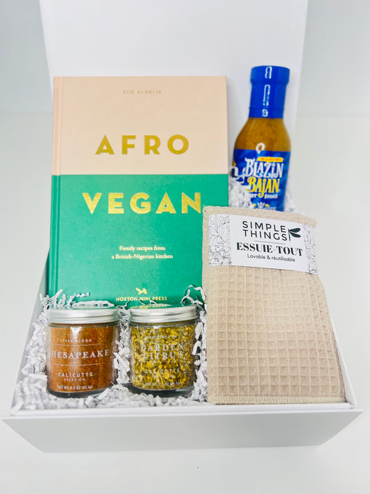 The "Seasoned" gift box by Sonia's Vokalized Kreations includes the Afro-Vegan cookbook, Barbados hot pepper sauce, a seafood spice blend with Chesapeake and Garlic Zestar spices, plus a cozy beige textured cloth.