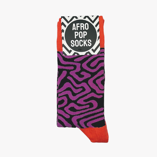 Roots Purple by Sonia's Vokalized Kreations features Afro Pop Socks with purple and black abstract designs highlighted by orange, bringing a bold and lively touch to any outfit.