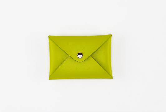 A lime green wallet with snap button closure from the Pompei & Brooklyn Bundle by Sonia's Vokalized Kreations, elegantly displayed against a crisp white background.