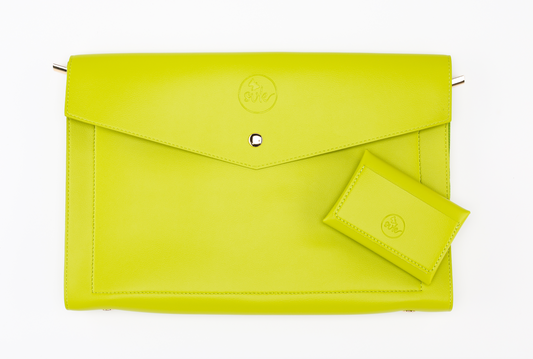 A lime green leather Pompei & Brooklyn Bundle rests elegantly on a white background, embodying the essence of empowering women through style. Brand: Sonia's Vokalized Kreations.