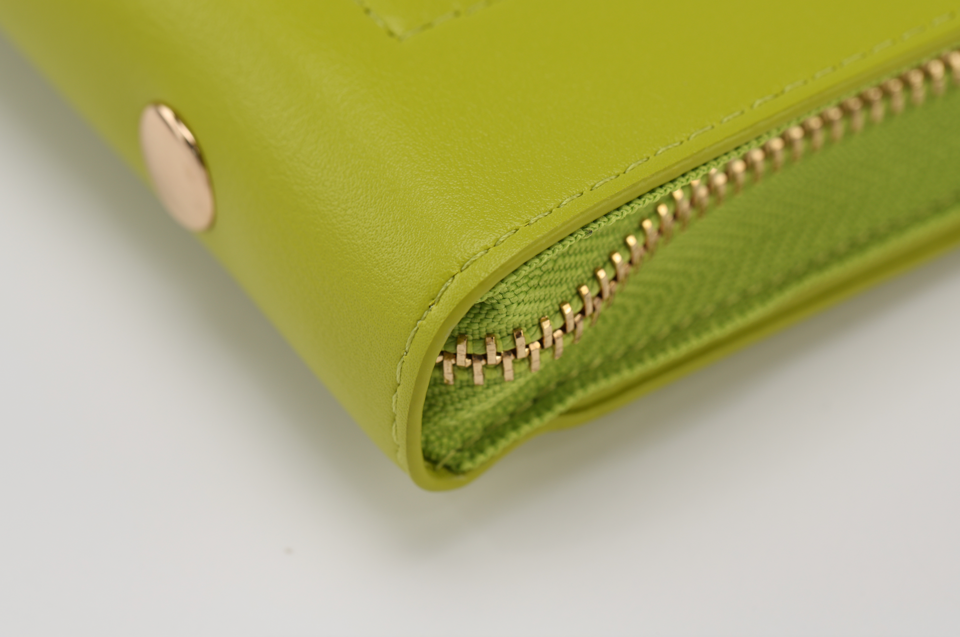 Close-up of the Pompei & Brooklyn Bundle by Sonia's Vokalized Kreations in lime green, featuring a textured design and gold zipper with button.