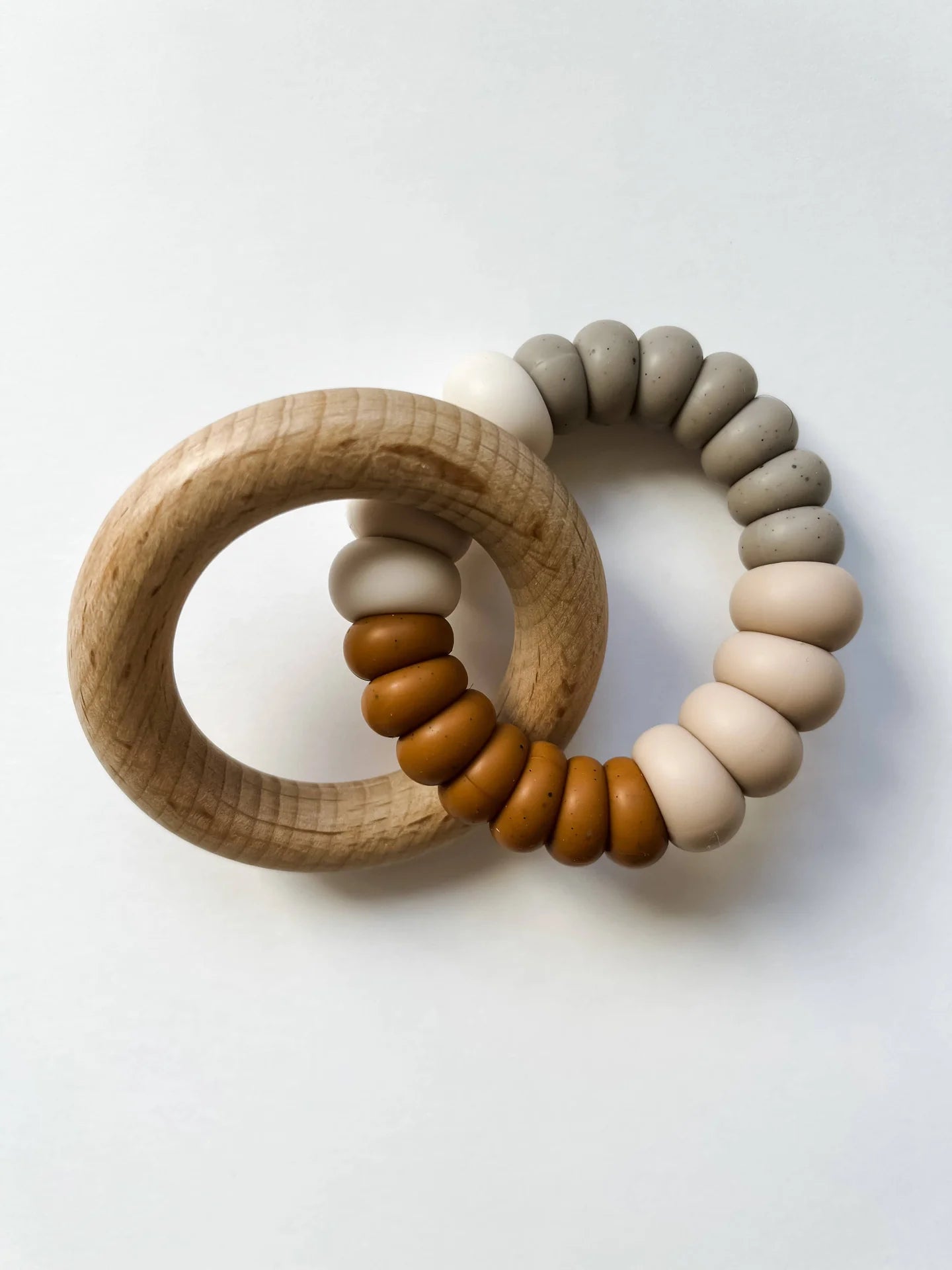 Sonia's Vokalized Kreations' New Baby Gift Box for Mom & Baby features a wooden ring interlinked with neutral silicone beads, perfect for shower or postpartum gifts, shown on a white background.