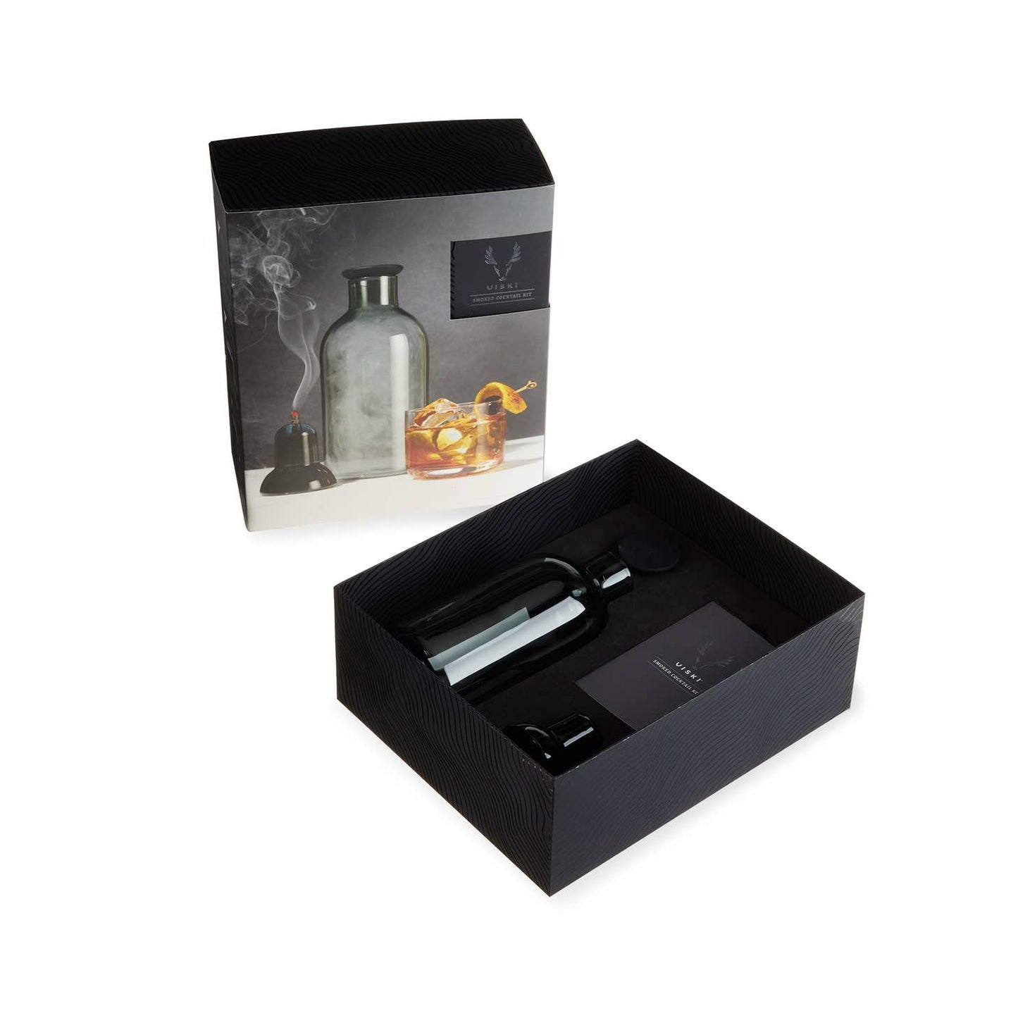 The Alchemi Smoked Cocktail Kit by sonia's-vokalized-kreations comes in a stylish black gift box. It includes a smoke infuser, glass dome cover, and accessories. The packaging displays the inventive smoke rinse method used to create deliciously smoked cocktails.