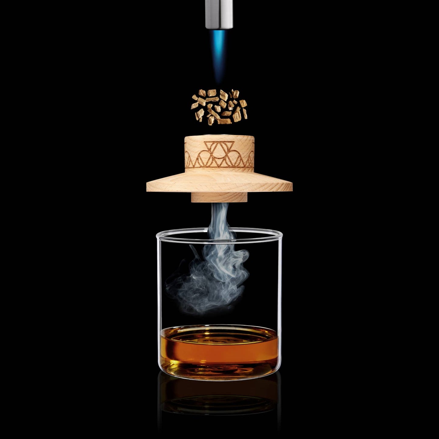 On a stark black background, the AlchemI Single Serve Smoked Cocktail Kit by sonia's-vokalized-kreations gracefully envelops wood chips over a glass of rich, amber liquid.
