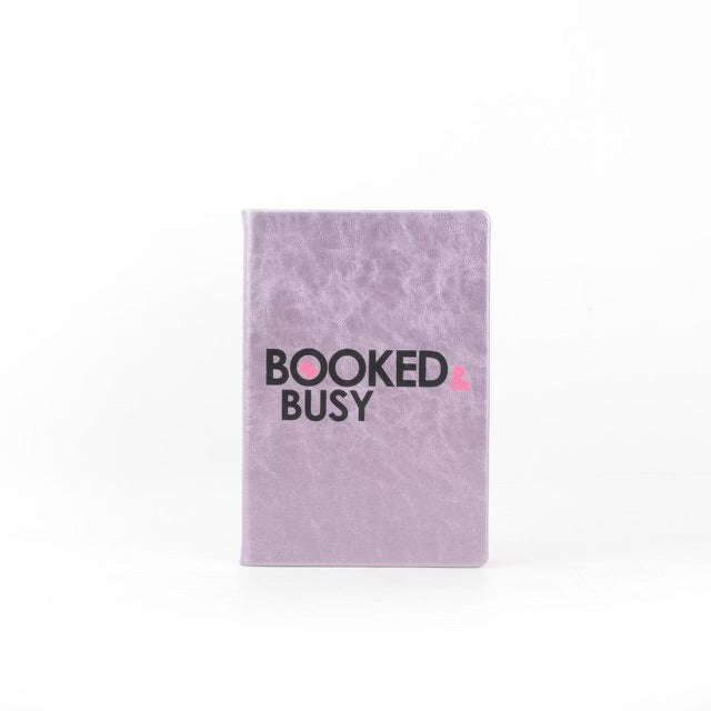The "Boss Chic Essentials" by sonia's-vokalized-kreations features a purple notebook with "BOOKED & BUSY" on a white backdrop, ideal for entrepreneurial women seeking organization.