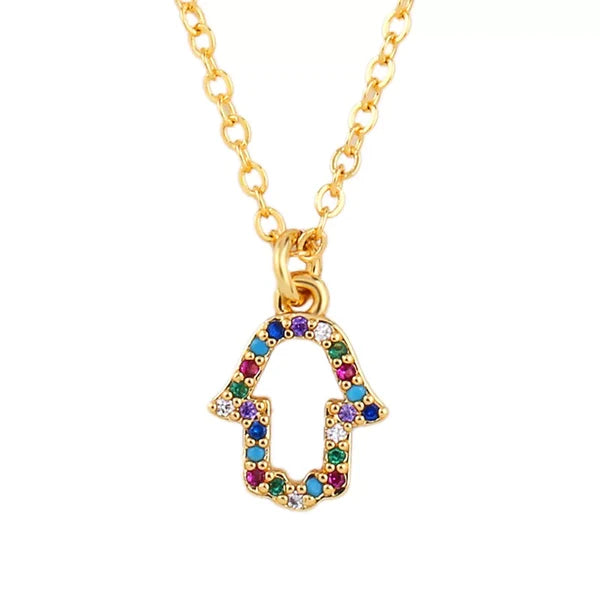The "Don't Disturb My Peace" gold chain necklace by Sonia's Vokalized Kreations features a hamsa pendant adorned with colorful gemstones, symbolizing inner harmony and tranquility.