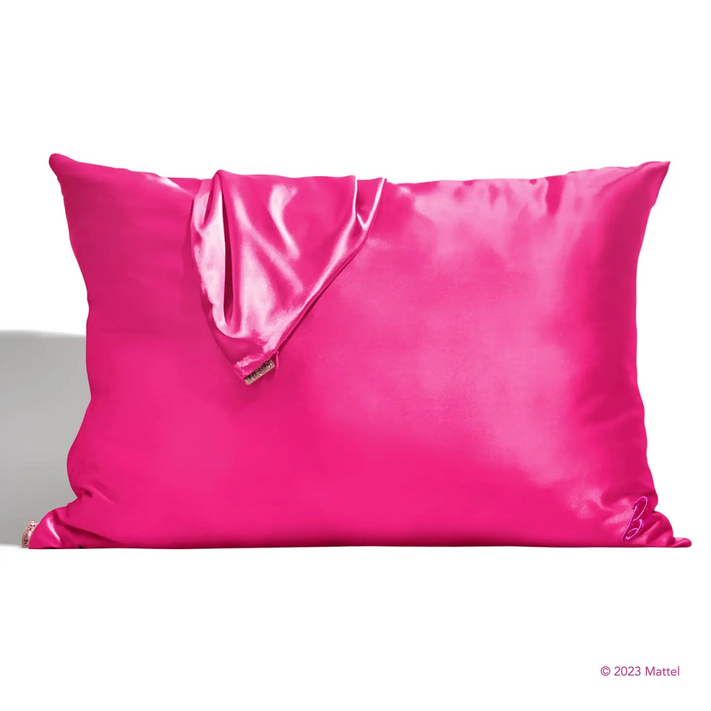 A shiny, bright pink pillow with a coordinating eye mask provides beauty sleep akin to Barbie's, designed to prevent facial creases. This set radiates luxury and style as part of the exclusive Sonia's Vokalized Kreations Satin Pillowcases collection.