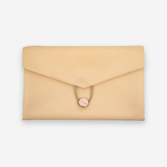 The Daily Daisy Swaddle Bag by Sonia's Vokalized Kreations is a beige fabric envelope clutch with a button and loop closure, providing both style and function.