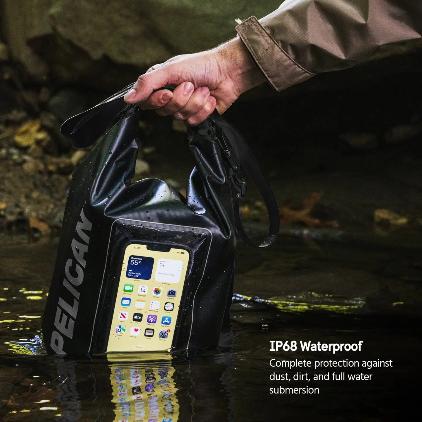 A hand holds the Sonia's Vokalized Kreations Pelican Marine Waterproof 5L Dry Bag (Stealth Black) - Phone Pouch, showing a visible phone inside, partially submerged; text reads "IP68: Total dustproof & underwater protection.