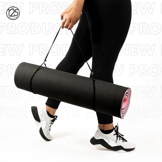 A person carrying Sonia's Vokalized Kreations' "Inhale the Future Exhale the Past" eco-friendly black yoga mat with a strap, wearing black leggings and white sneakers against a backdrop of overlapping "NEW PRODUCTS" text.