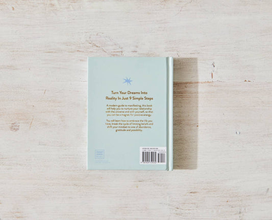 The back cover of "Manifesting For Beginners" by Victoria Jackson from sonia's-vokalized-kreations rests on a light wood surface, featuring an inspiring star illustration that promises a transformative journey of manifesting positive energy and mindset shifts to unlock your dreams.