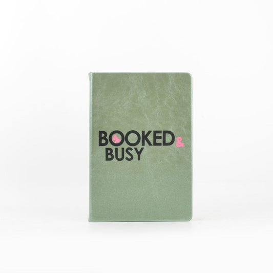The Booked & Busy Journal by sonia's-vokalized-kreations features "BOOKED & BUSY" on the cover, perfect for organizing your routine with style. Part of the Booked & Busy Journals collection, it helps keep you seamlessly on track.