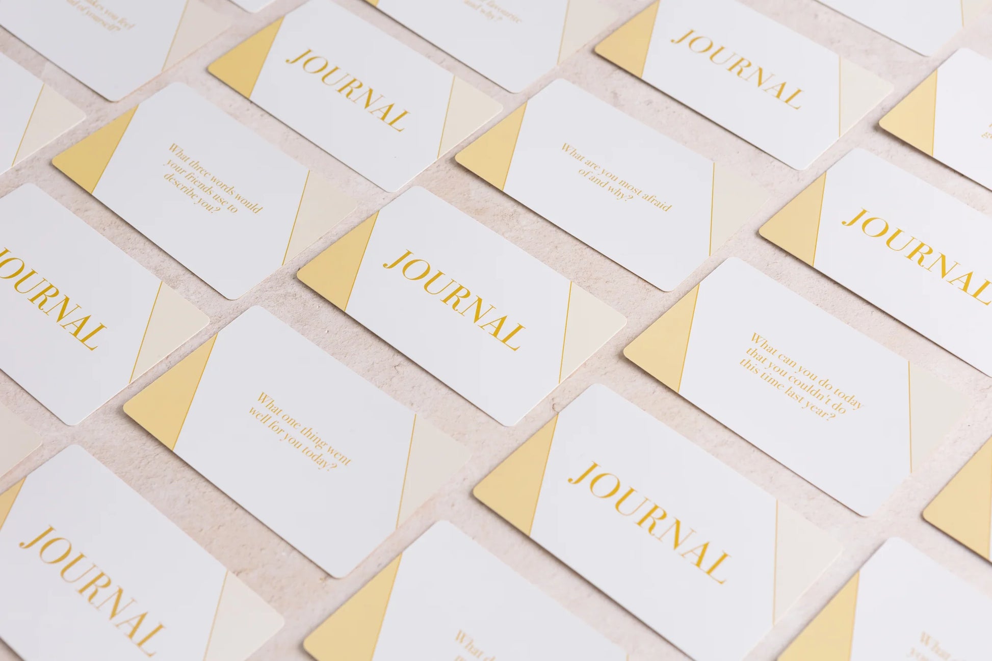 A collection of elegant white "Mind Cards: Journal Edition" by sonia's-vokalized-kreations, adorned with gold text and accents. Some cards include self-discovery questions to guide your self-development journey.