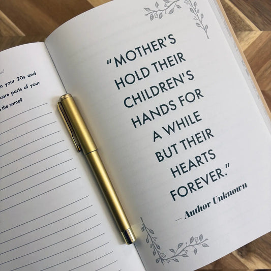 The "Mom, I Want To Hear Your Story; Heirloom Edition" by Sonia's Vokalized Kreations is an open journal with a gold pen and the heartfelt quote: "Mothers hold their children's hands for a while but their hearts forever." A timeless keepsake gift.