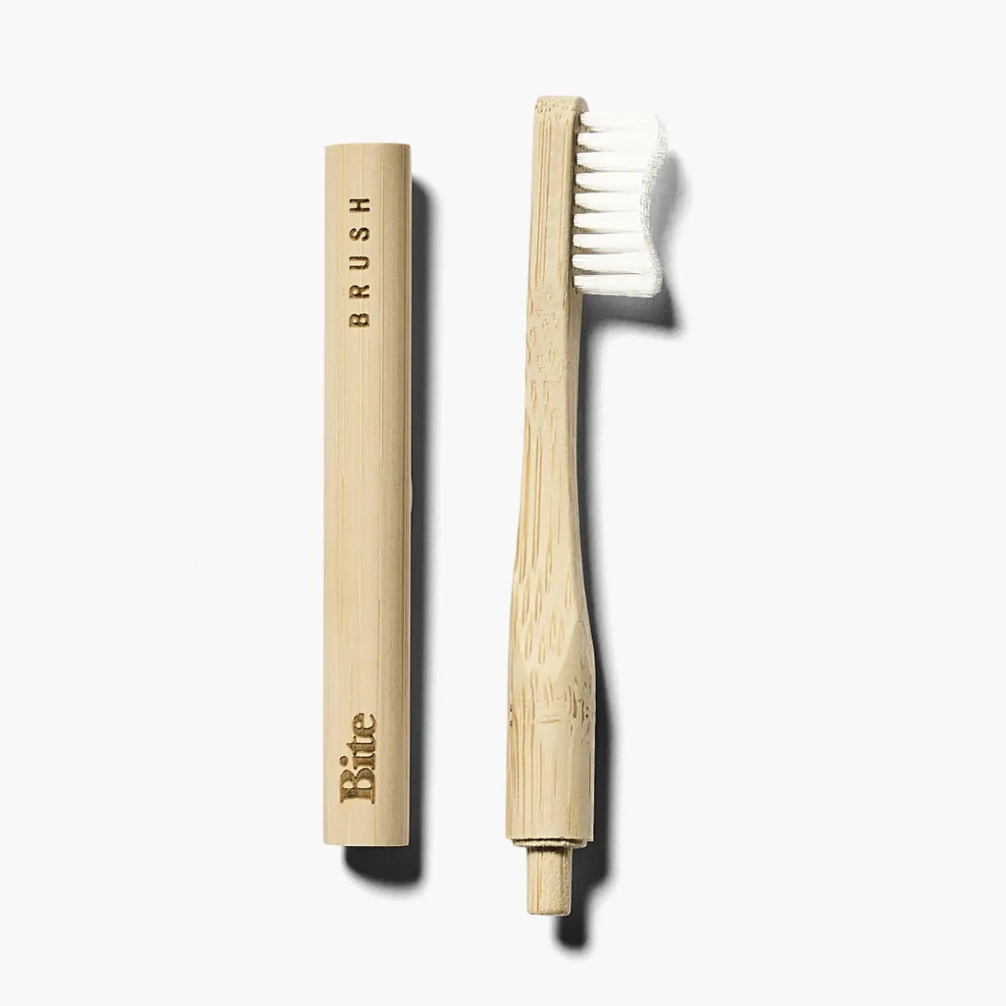 Bamboo toothbrush with holder on a white background